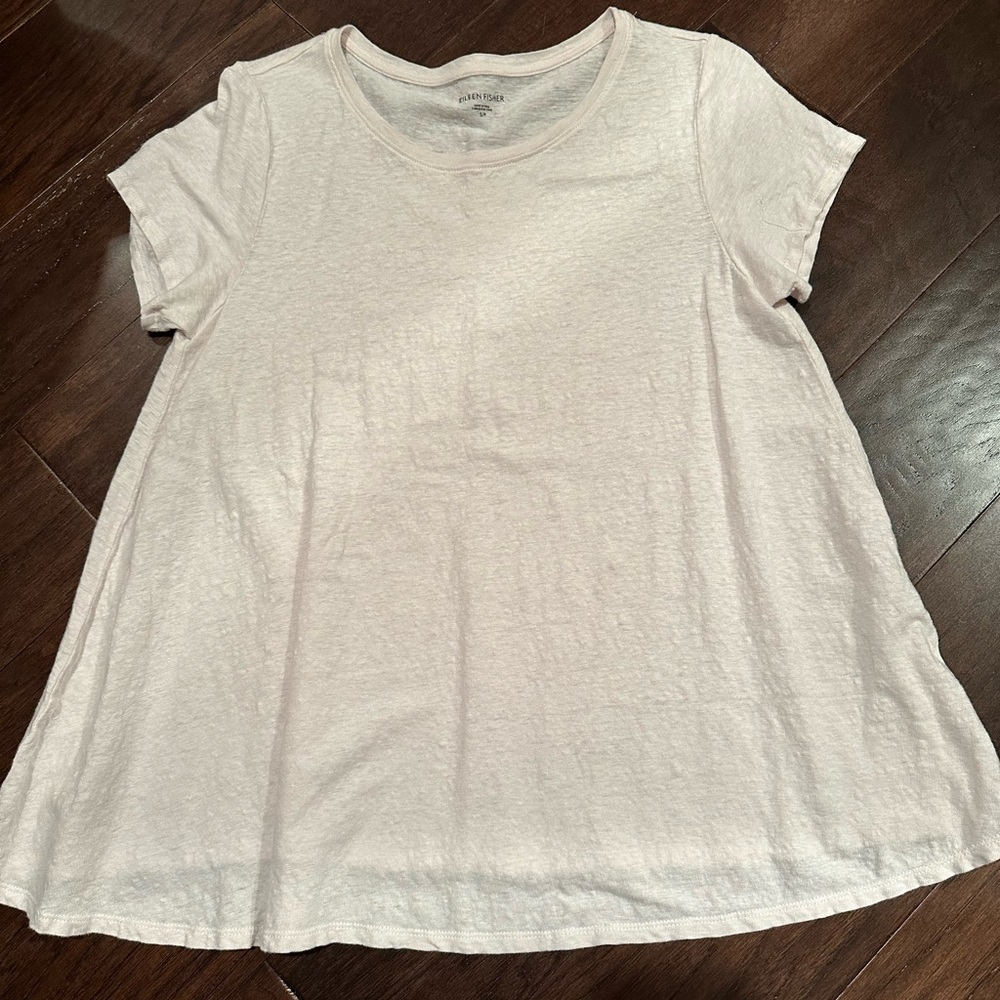 Eileen Fisher pale blush pink T.  Has a wide swingy bottom.  Easy wearing.